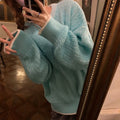 Women's loose retro pullover sweater in lake blue, shown in a casual setting.