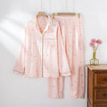 Women's beige cotton crepe pajama set with long sleeves and trousers on a hanger