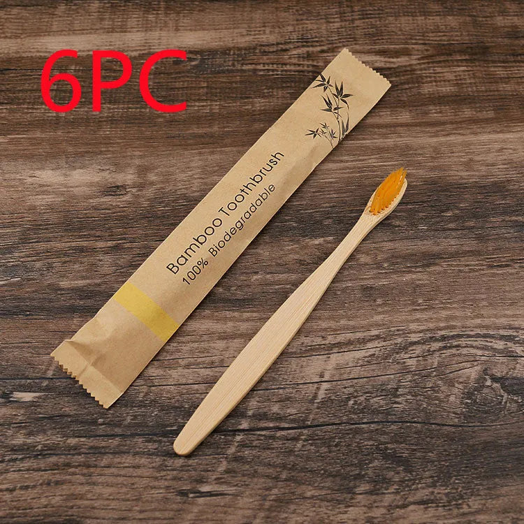 Set of ten bamboo toothbrushes with charcoal bristles in assorted colours on a plain background