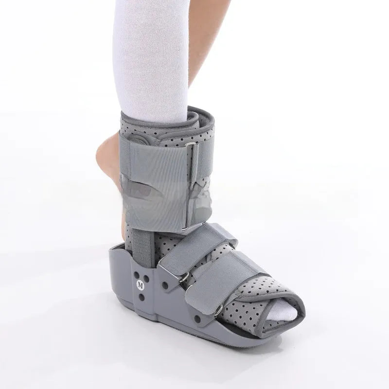 Grey and black Achilles tendon rehabilitation boot with adjustable straps and rocker sole for walking support.