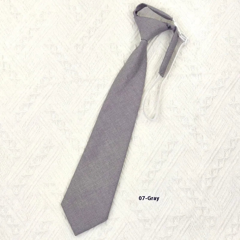 A navy blue cotton men's bow tie with an arrow style design on a white background.