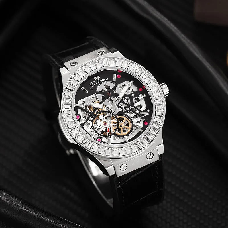 Men's automatic wristwatch with hollow dial showing mechanics, diamond studs on white case, on a black strap.