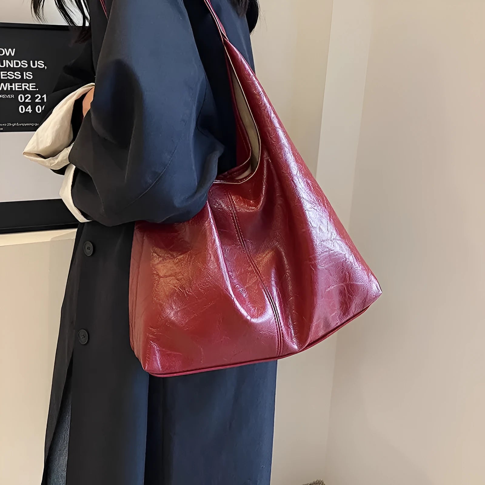 Soft PU leather large capacity shoulder bag in black with a sandwich pocket and contrasting stitching.