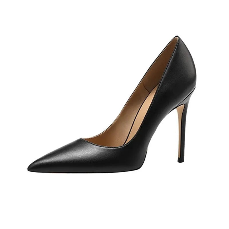 Black pointed-toe high heel pump with a stiletto heel on a plain background.