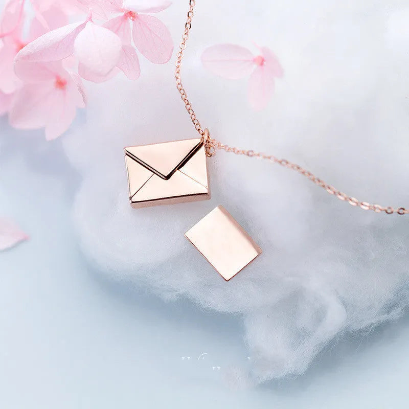 Titanium steel envelope pendant necklace with chain on a woman's neck, gold finish