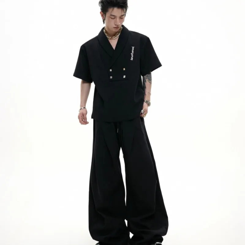 Men's dark grey cotton sports suit with padded shoulders, featuring a V-neck short-sleeve shirt and matching shorts.
