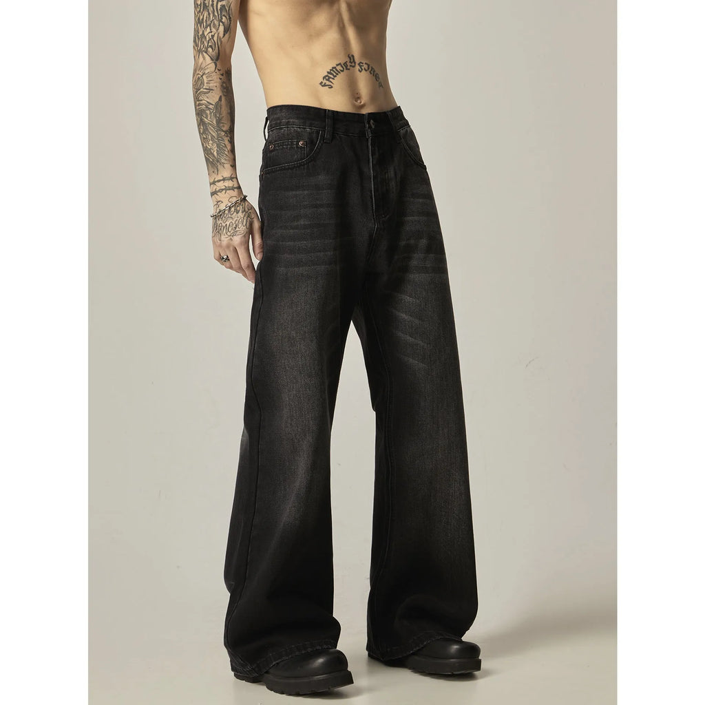 Black loose straight-leg jeans with a retro light wash and zip fly closure laid flat.