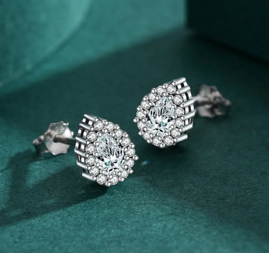 A pair of women's silver drop ear studs made from 925 sterling silver with a teardrop shape.