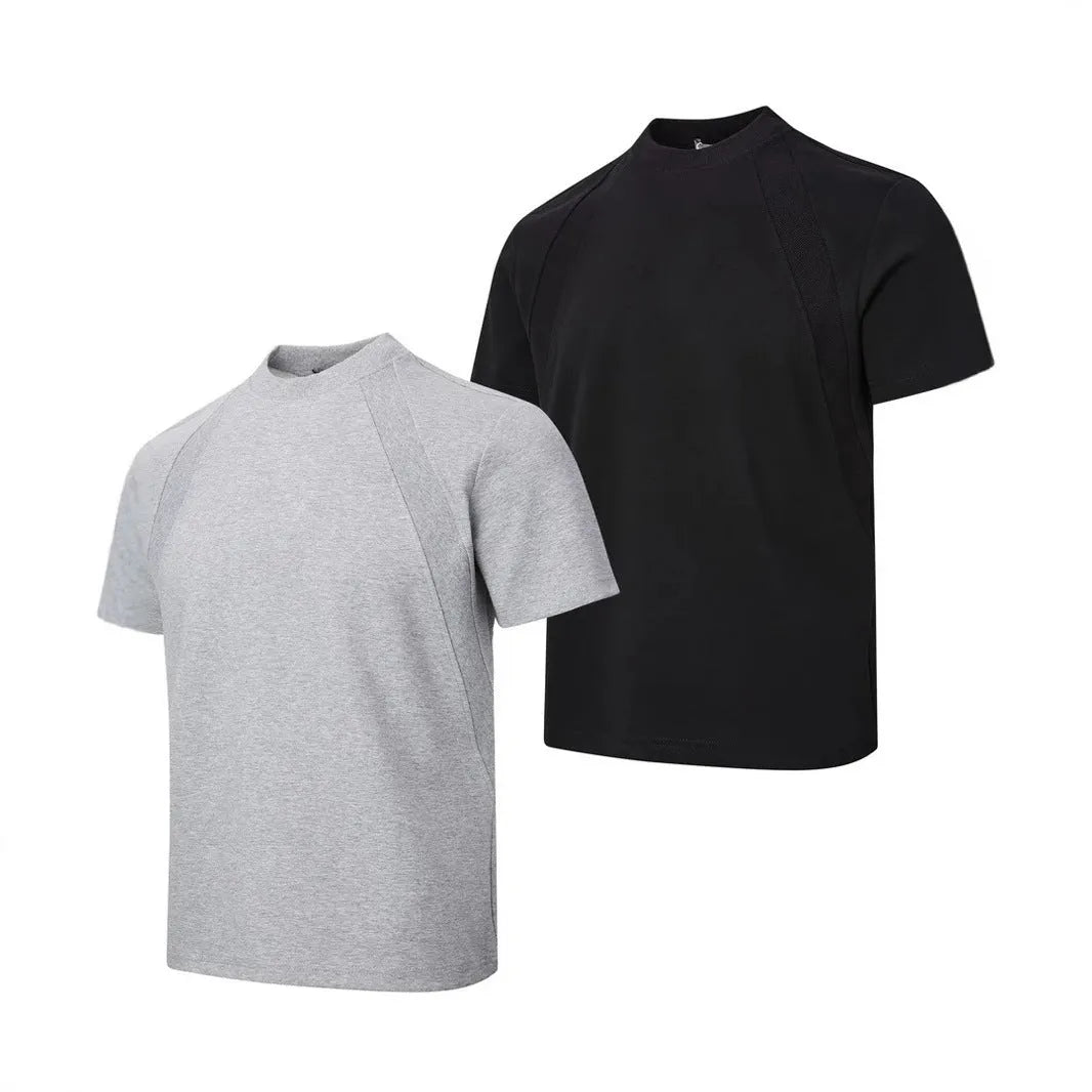 Men's loose fit short sleeve top in black with air layer stitching detail on a grey background.
