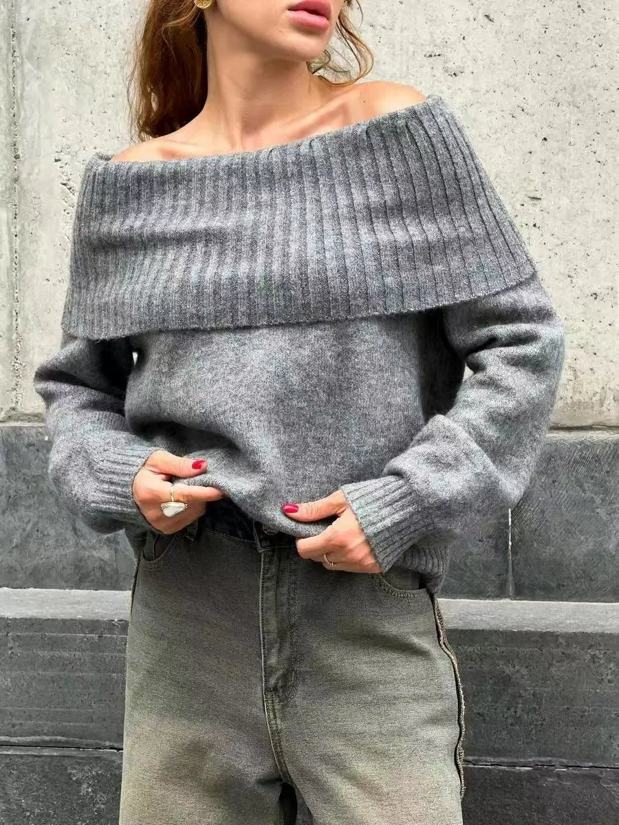 Grey off-the-shoulder sweater with a 3D pattern, shown on a model.
