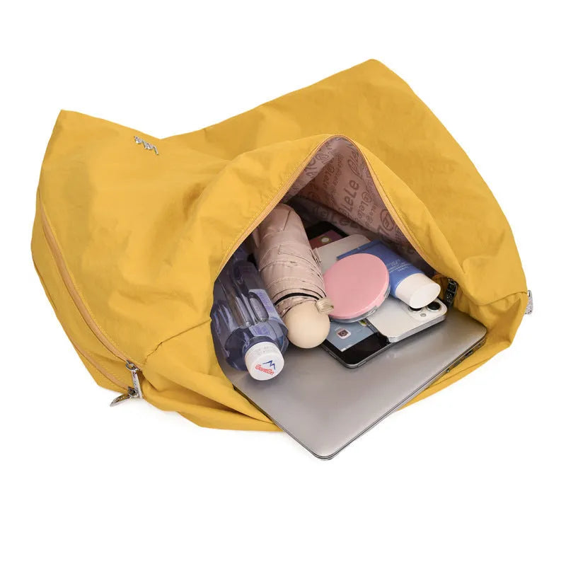 Soft heart-shaped nylon underarm bag for women shown in black, blue, khaki, and yellow.
