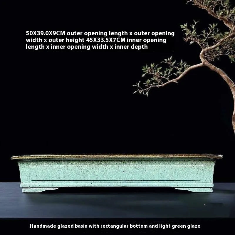 Green handmade ceramic bonsai flower pot with a purple sand crackled glaze finish.