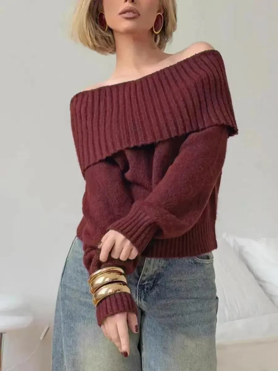 Grey off-the-shoulder sweater with a 3D pattern, shown on a model.
