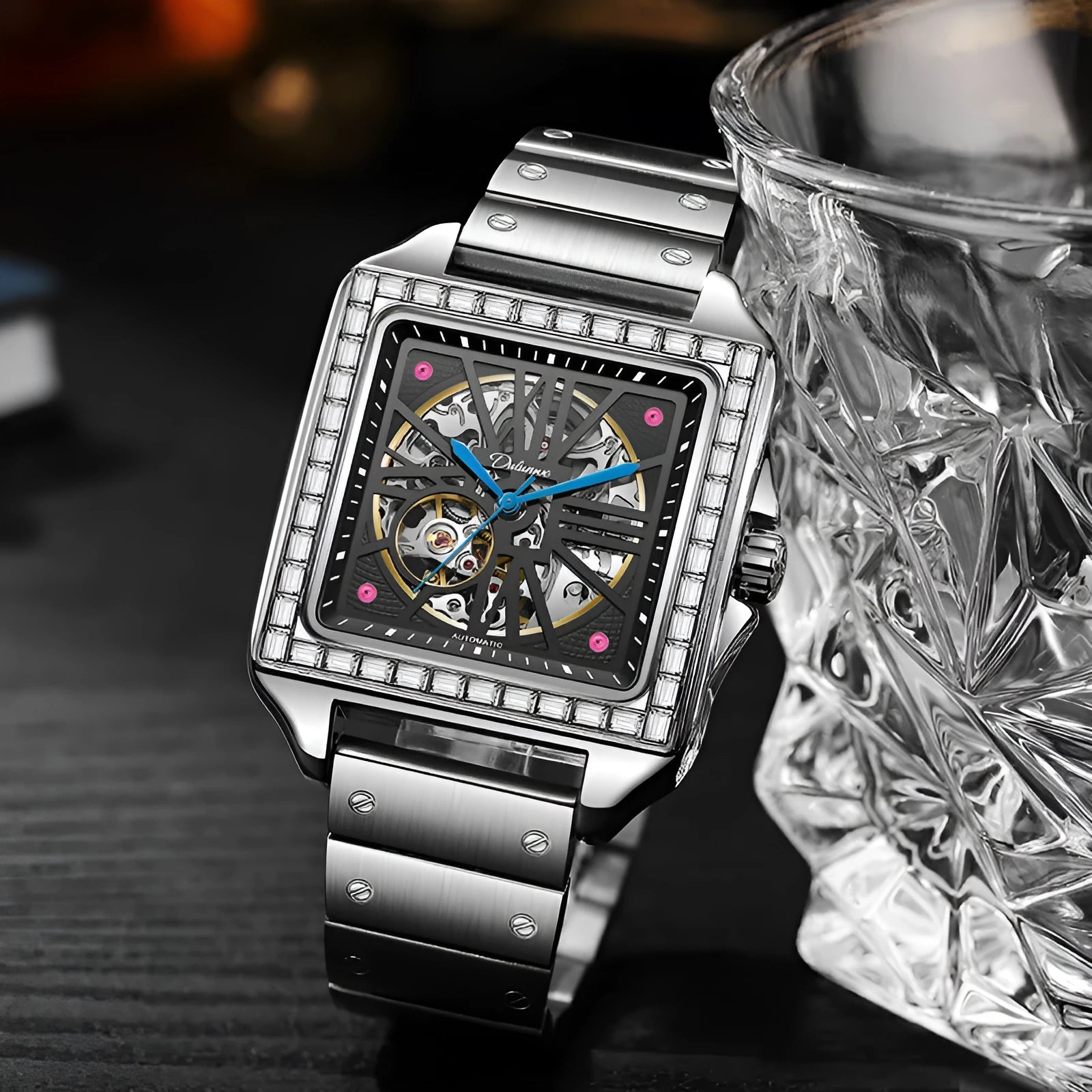 Men's square-faced automatic watch with diamond studs on a stainless steel bracelet.