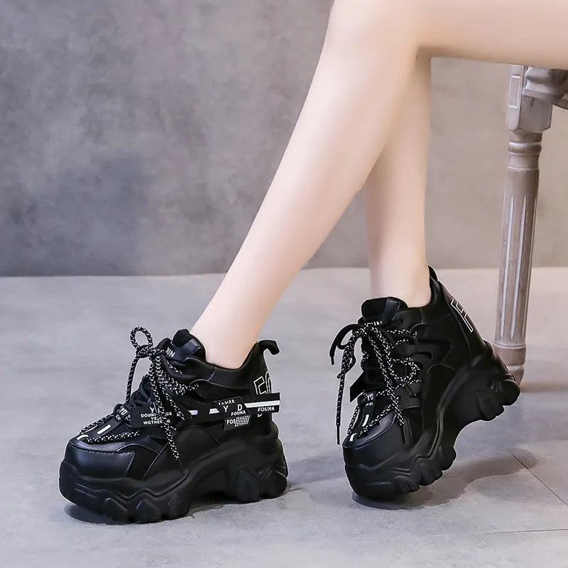 White women's low-top platform sports shoes with a cross-strap and breathable mesh upper on a rubber sole.