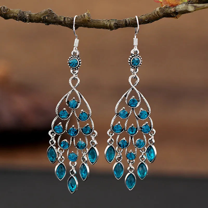 Purple retro drop earrings with long crystal fringe detailing and ethnic styling elements