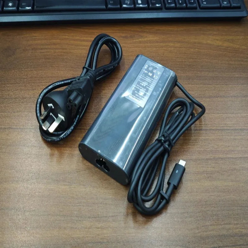 Black 65W laptop Type-C power adapter with multiple international plug cords
