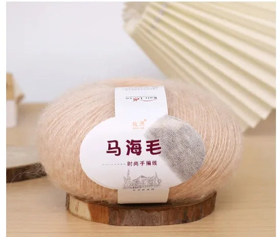 Ball of mohair yarn for DIY scarf knitting in one of 34 colours, including white, pink, blue, and green.