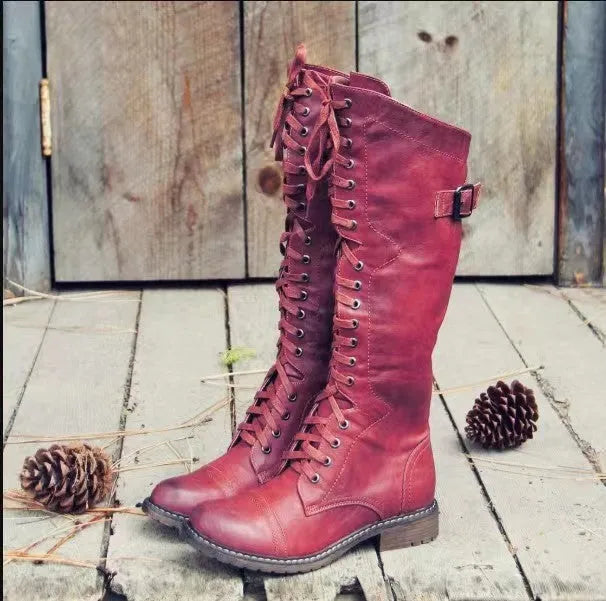 Women's black chunky heel high leg boots with a round toe and low profile.