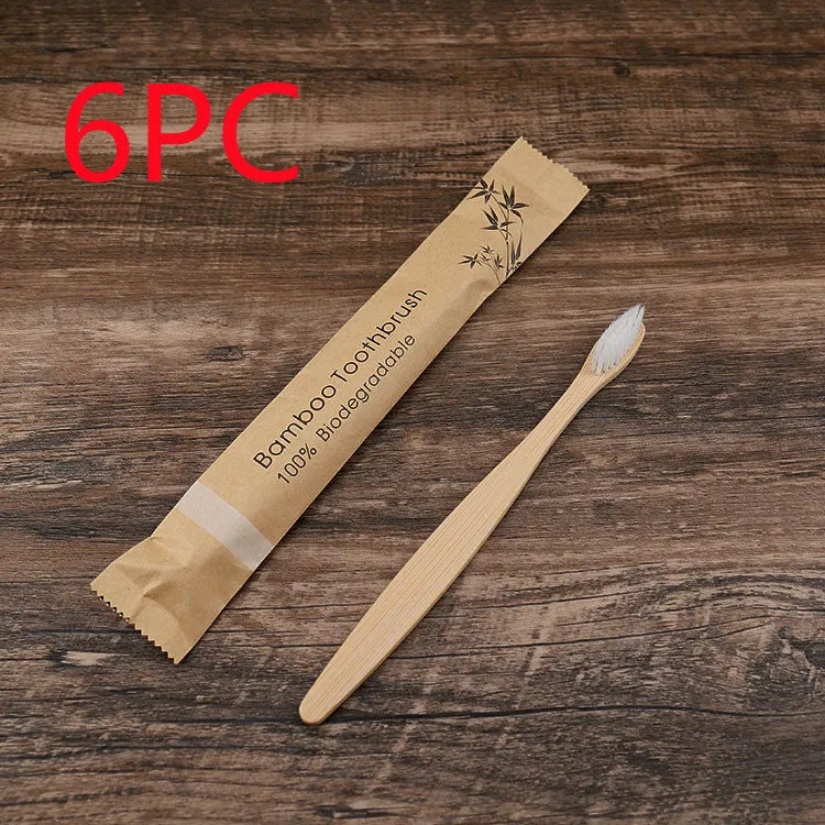 Set of ten bamboo toothbrushes with charcoal bristles in assorted colours on a plain background
