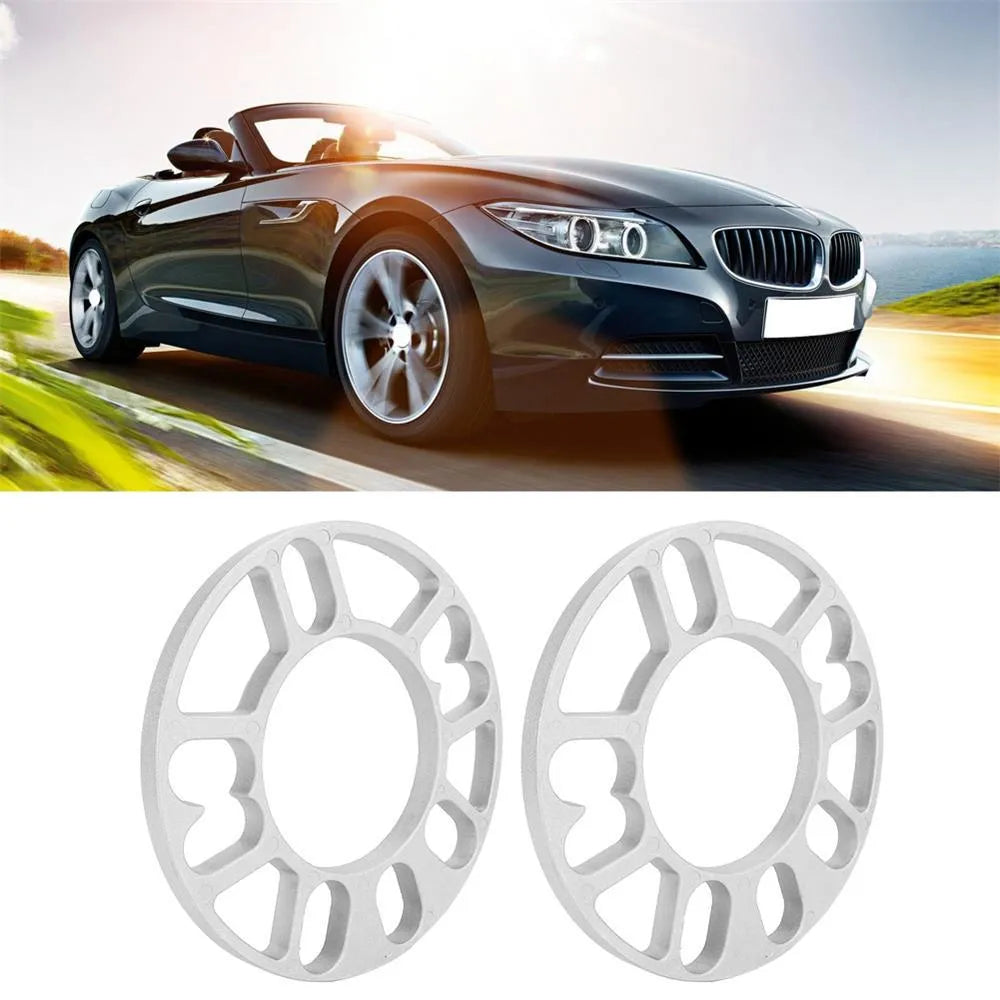 Set of metal hubcentric wheel spacer gaskets in different thicknesses for car brake caliper clearance.