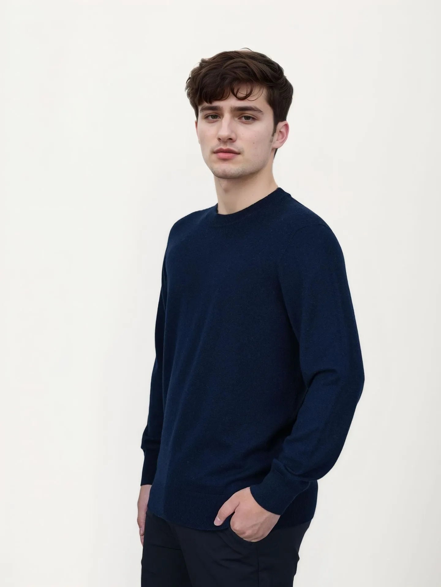 Man wearing a standard wool pullover sweater in light grey, regular fit, for autumn and winter.