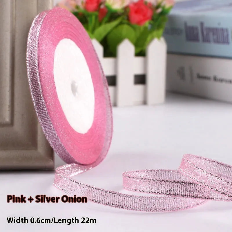Roll of narrow 0.6cm wide polyester gift ribbon in a multicolour pattern.