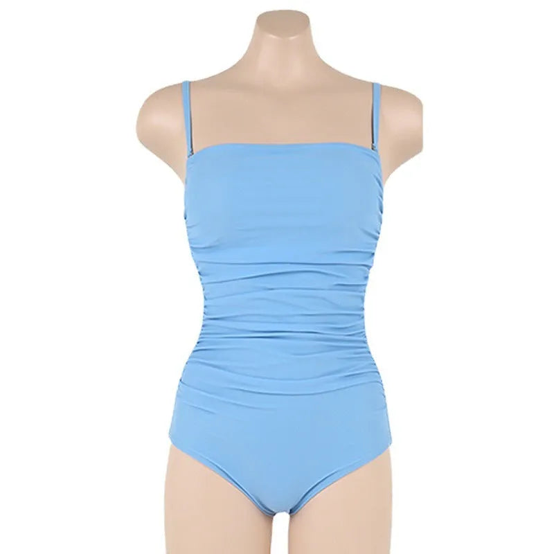 Blue sling style one-piece swimsuit with belly pleating on a model