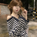 Dark blue women's oversized long-sleeve t-shirt with embroidery and stripe details on a hanger.