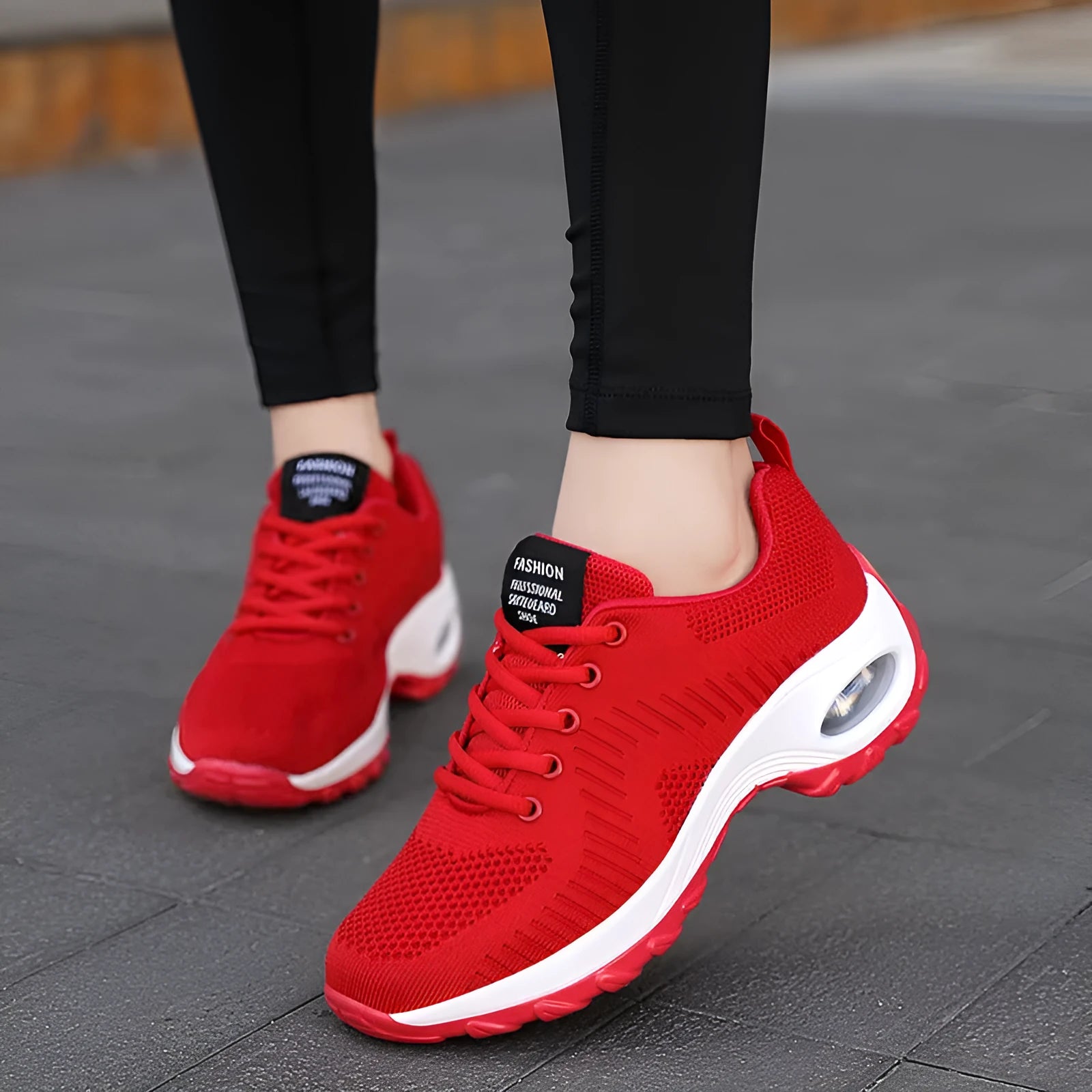 Women's round toe red and black mesh sneakers with front laces on a flat heel and textured PU sole.