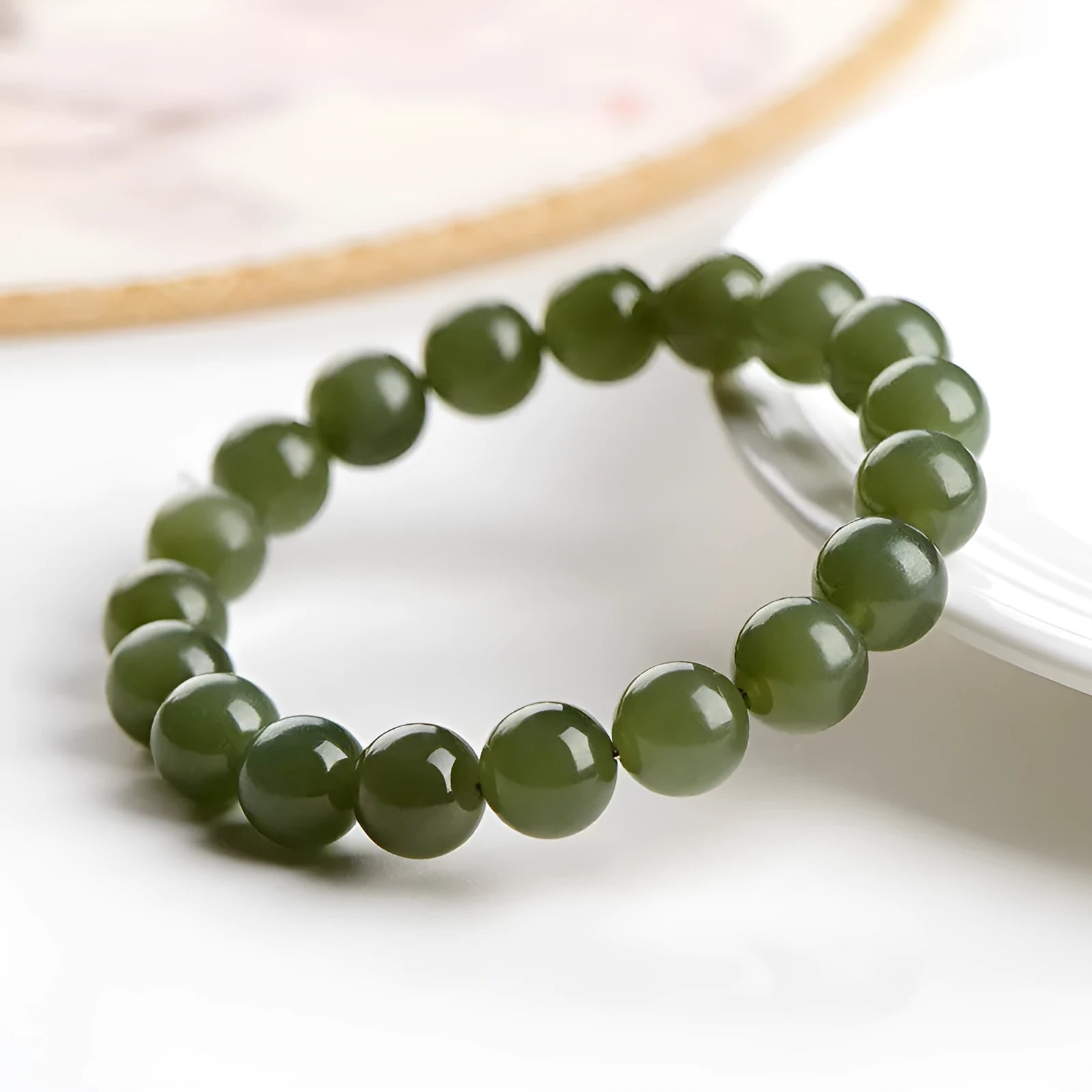 Polished Hetian jade ball bracelet on wrist, showing ice-like clear beads in available 4mm, 6mm, 8mm, and 10mm sizes.