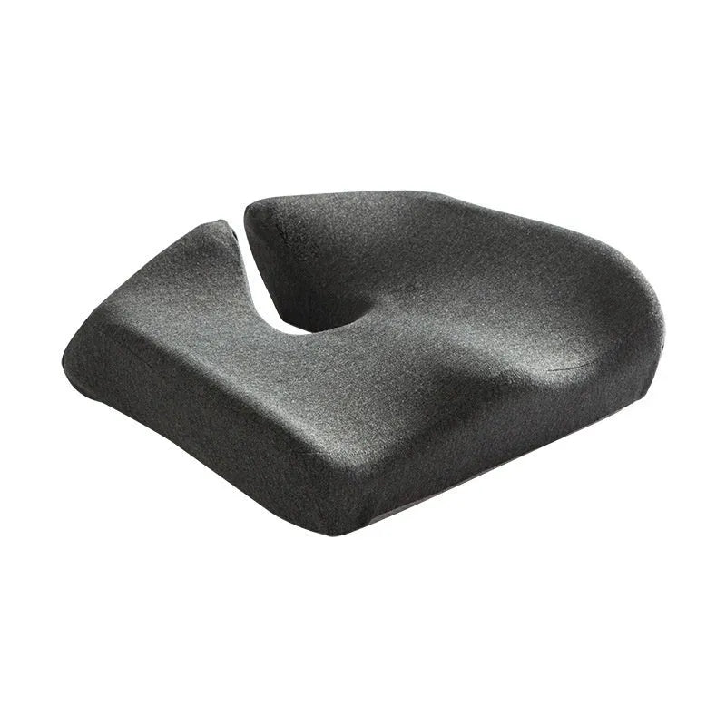 Dark grey memory foam office chair cushion for lumbar support on a desk chair.