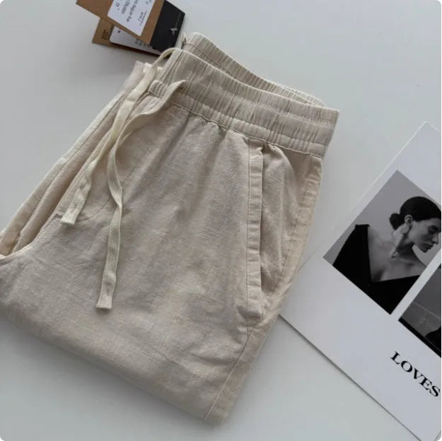 Men's loose fit straight leg casual trousers in beige with a drawstring waistband.