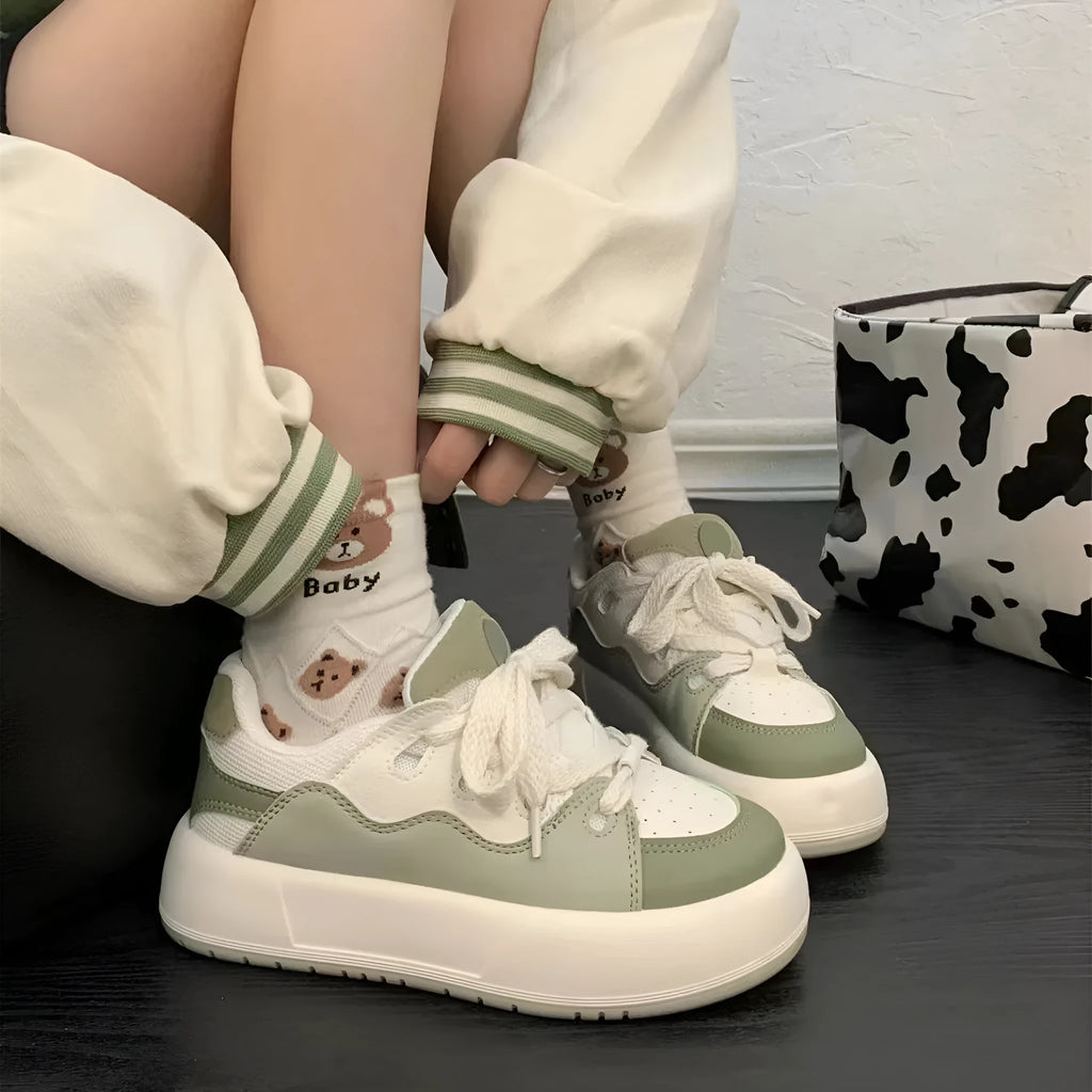 Green women's casual shoes with round toe, flat heel, and breathable mesh upper.