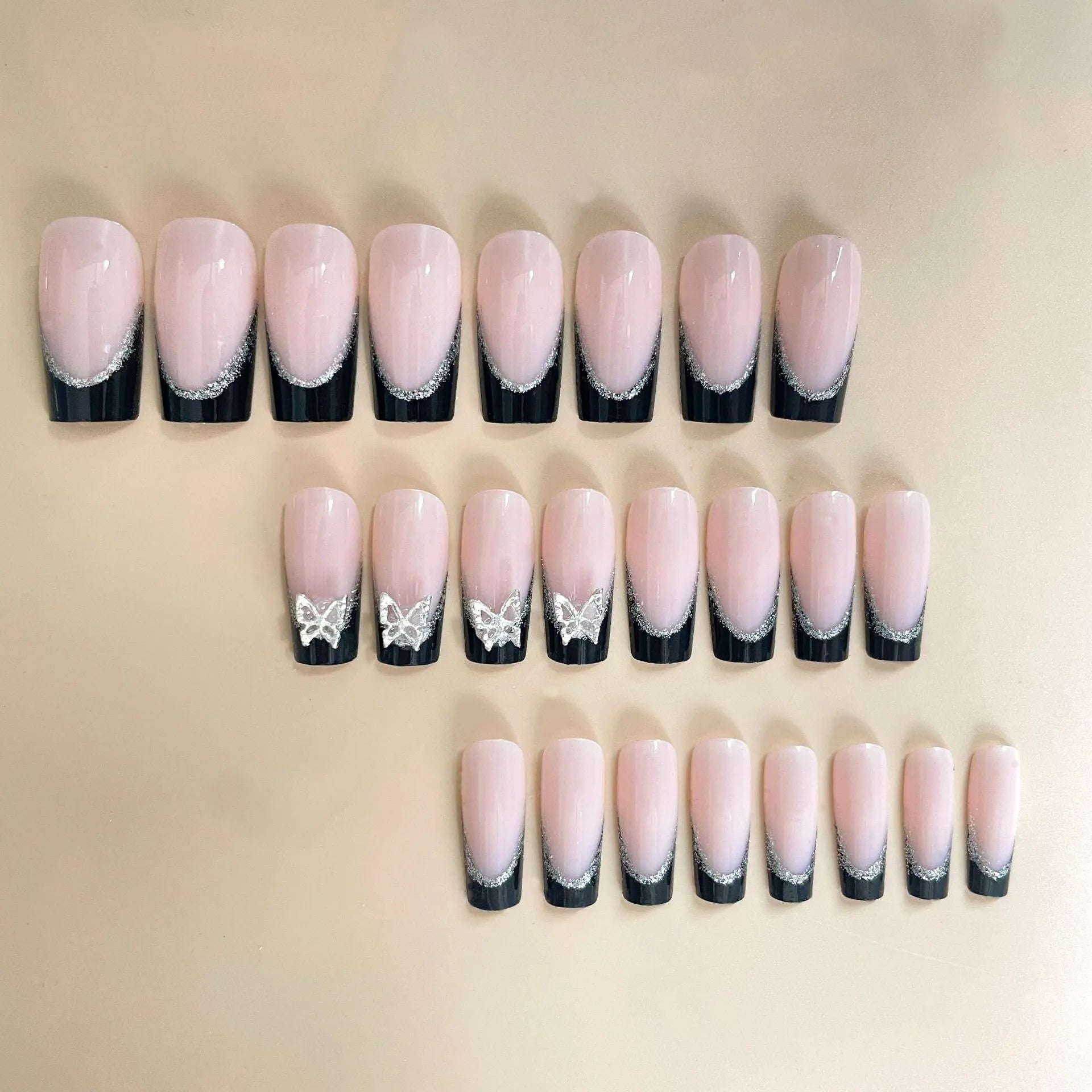 Black French style artificial nails with glitter butterfly design in medium length