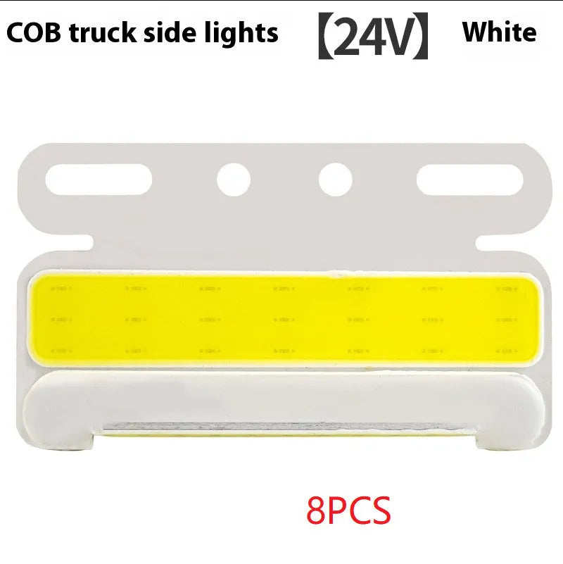 Aluminium alloy COB LED truck side light projecting bright white light onto ground next to tyre.