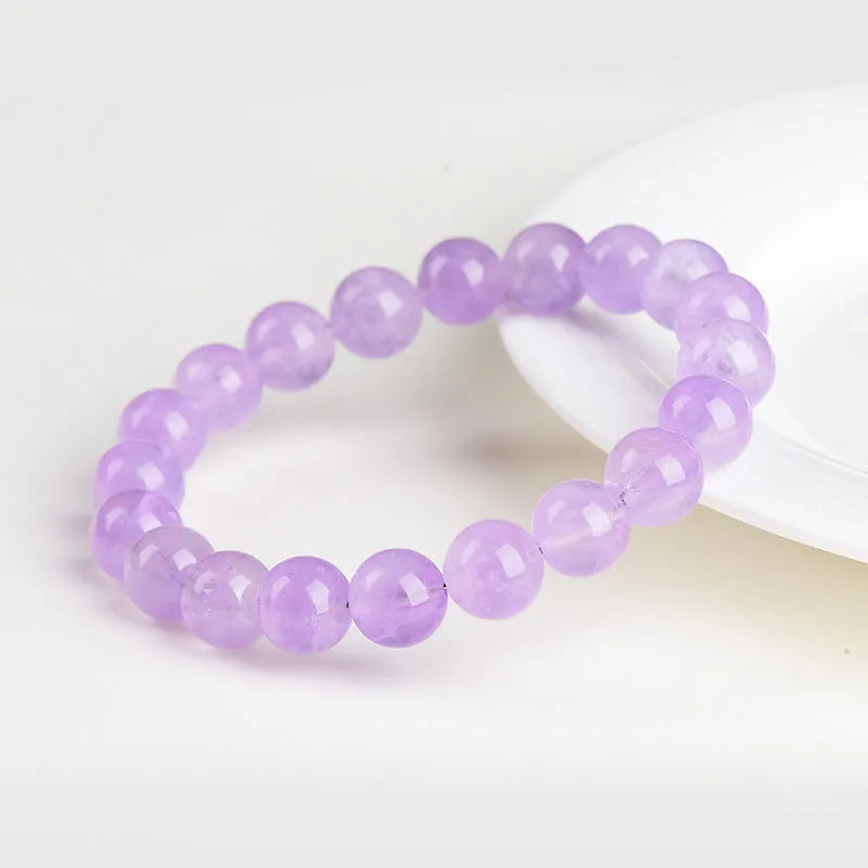 Lavender coloured amethyst crystal bead bracelet with round geometry shape and water ripple design.