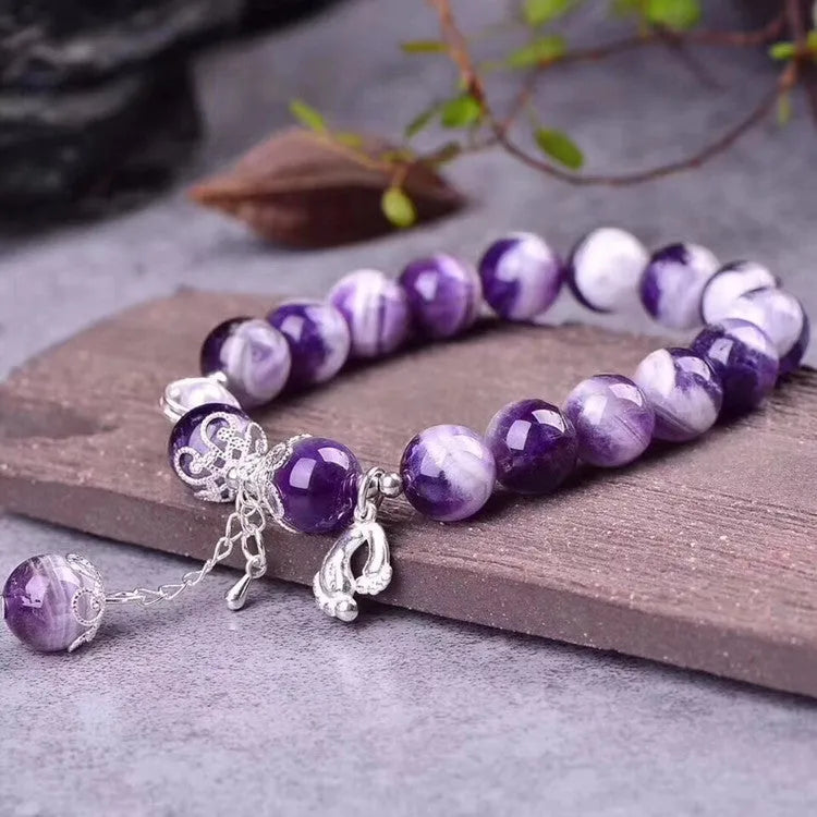 Purple amethyst gemstone bracelet with 10mm round beads on woman's wrist