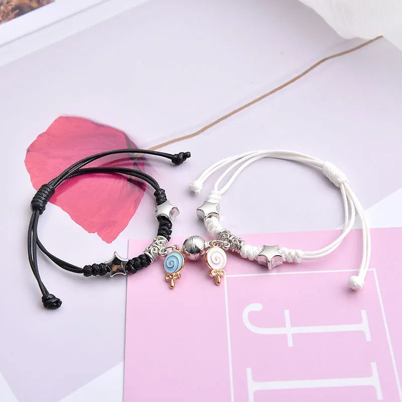 Magnet suction couple bracelets with alloy construction and various pendant designs including crowns and hearts