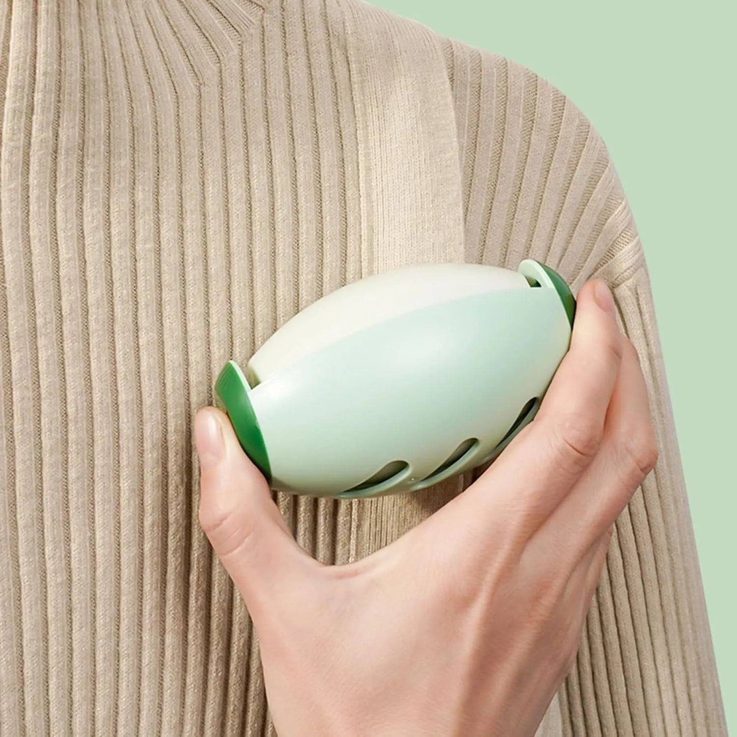 Green and white washable reusable gel lint roller ball for pet hair removal.