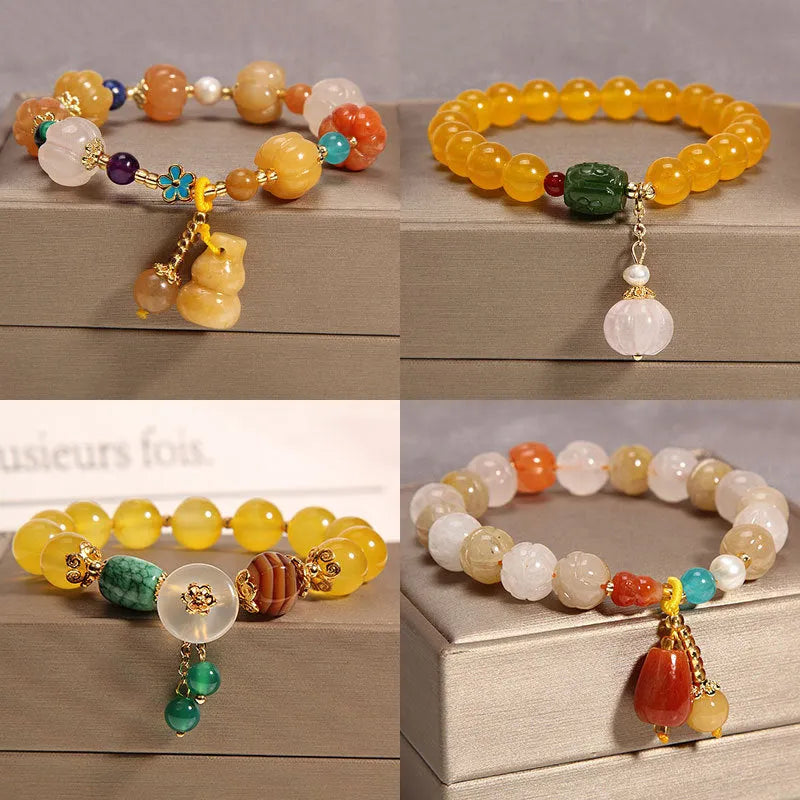 Yellow agate crystal bead bracelet on a gold silk cord with an adjustable metal clasp.