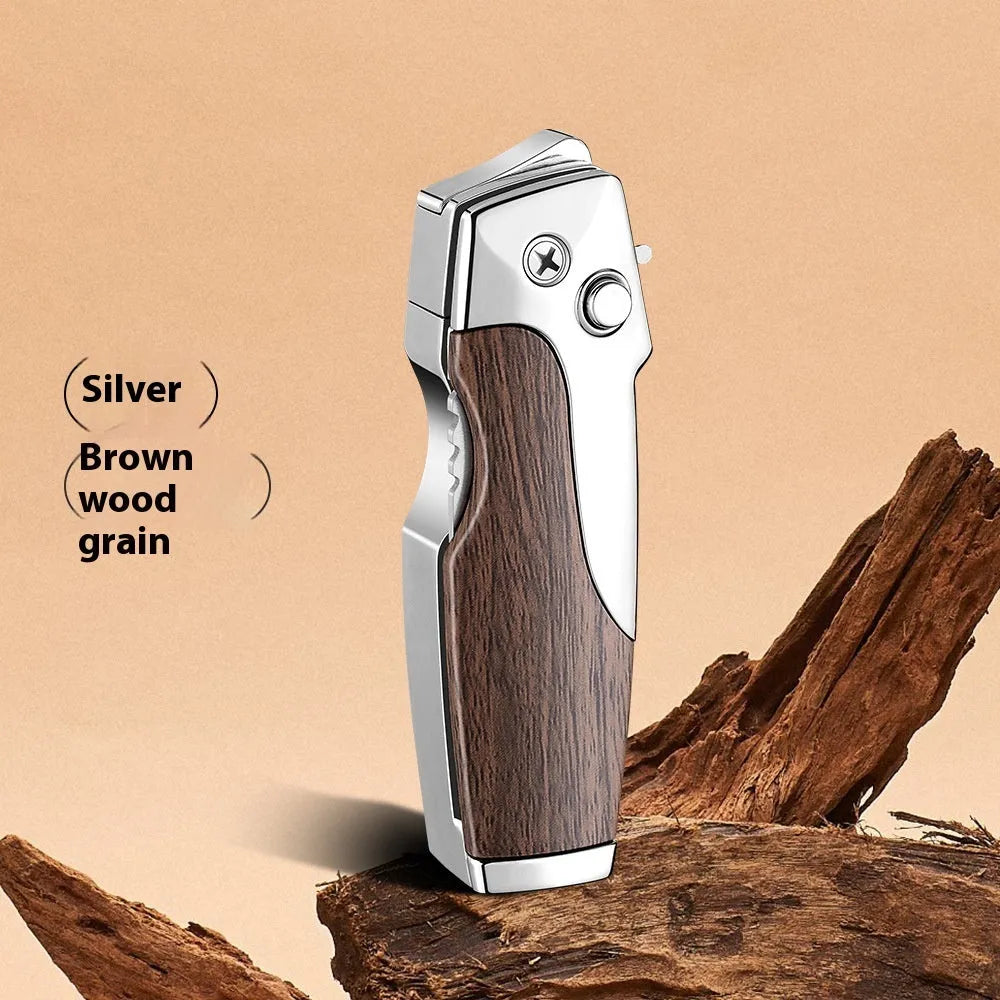 Closed metal folding lighter with integrated knife in a carbon fibre finish, showing the safety lock and refill valve.