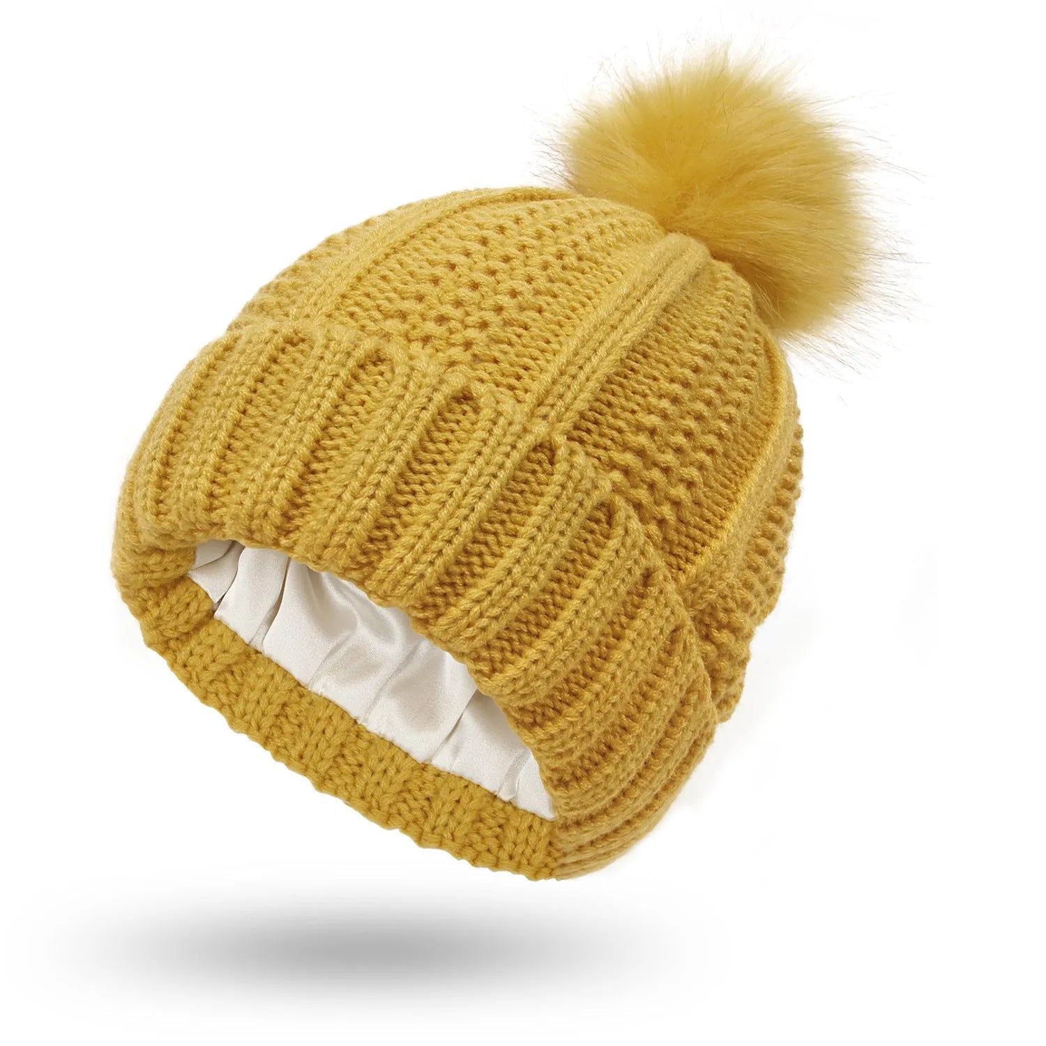Women's knitted beanie hat with faux fur pom pom and satin lining in multiple colour options.