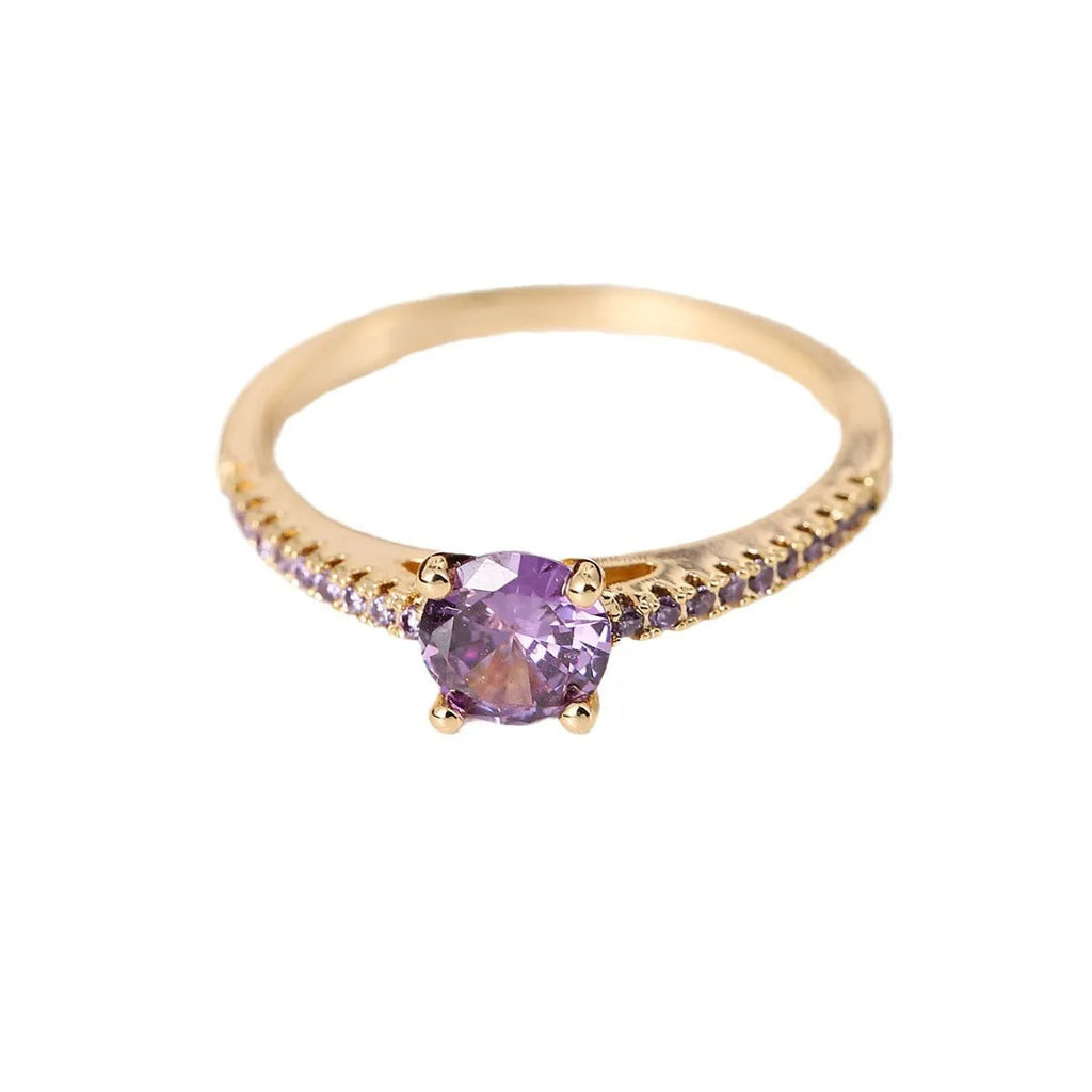 Geometric hexagonal copper ring with a zircon stone, shown in a gold rose red electroplated finish on a size 7 finger.