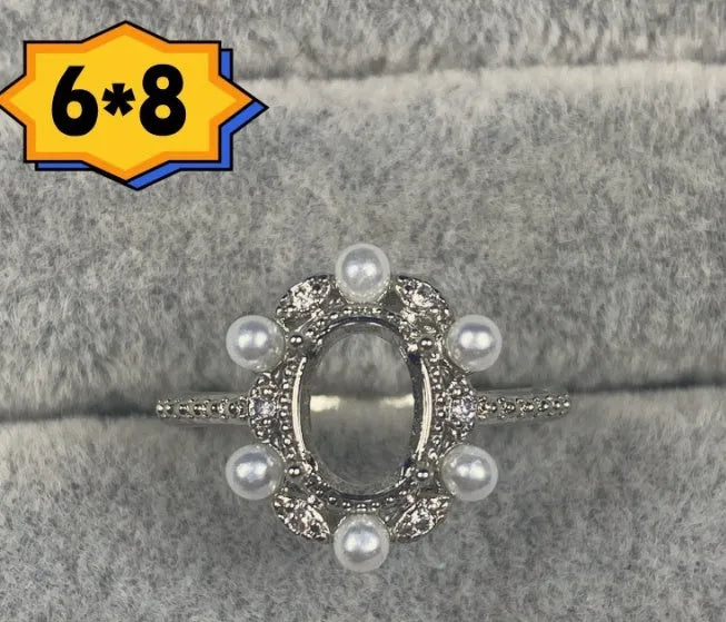 Oval denier fashion ring with open mouth setting, five-pointed star, and 6x8mm stone on copper band.