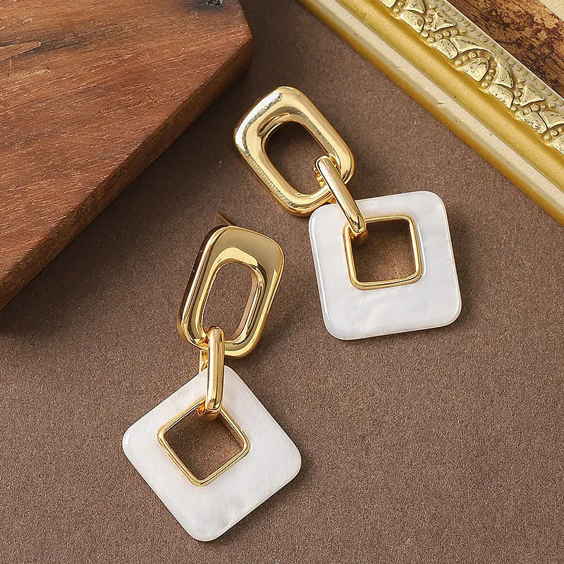 Hollow geometric square earrings with chamfered corners in electroplated copper