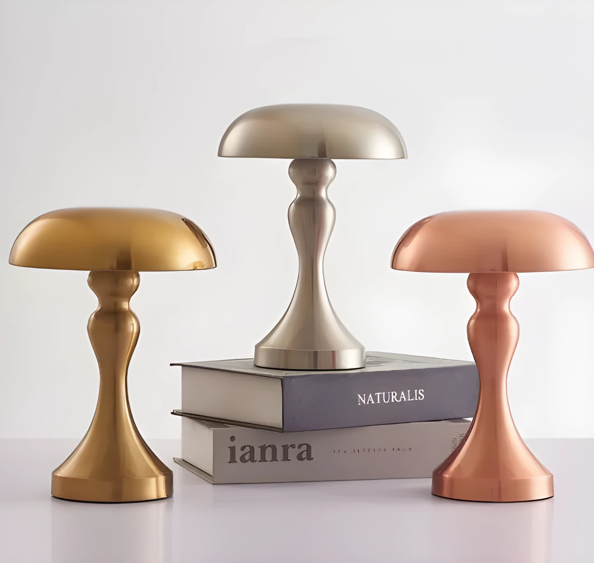 Metallic bronze touch-control LED desk lamp showing tri-colour light settings on a wooden desk.