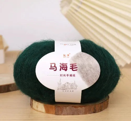 Ball of mohair yarn for DIY scarf knitting in one of 34 colours, including white, pink, blue, and green.