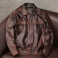 A man's black plus size PU leather jacket with a lapel and side pockets, shown on a hanger.