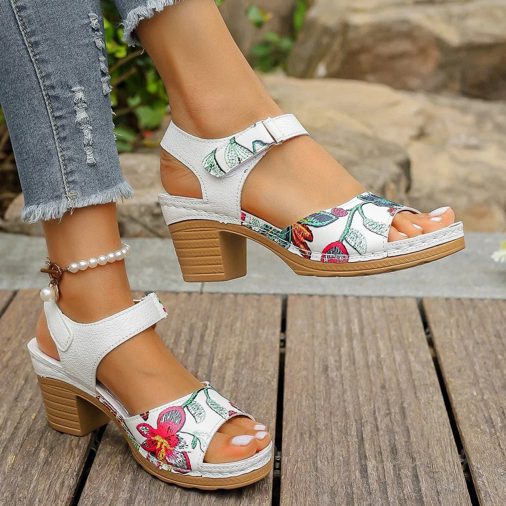 White women's high heel sandals with a Velcro strap buckle on the ankle.